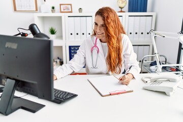 Fototapeta na wymiar Young redhead woman wearing doctor uniform working at hospital