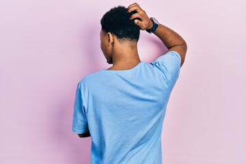 Young african american man wearing casual blue t shirt backwards thinking about doubt with hand on head - Powered by Adobe
