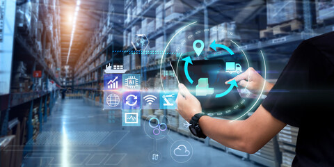 Business Logistics technology concept.Man hands using tablet on blurred warehouse as background