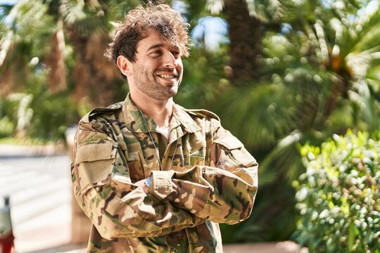 Young man army soldier smiling confident standing with arms crossed gesture at park