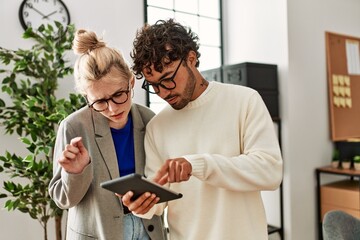Two business workers concentrated working using laptop at the office