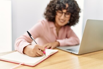 Young middle east businesswoman writing on diary working at the office.