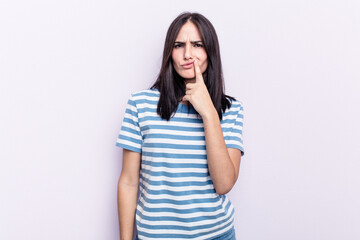 Young caucasian woman isolated on pink background thinking and looking up, being reflective, contemplating, having a fantasy.