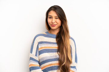 asian pretty woman looking happy and friendly, smiling and winking an eye at you with a positive...