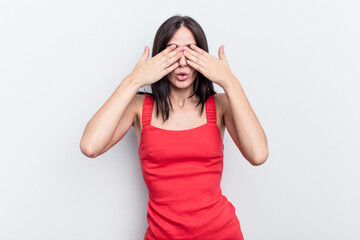 Young caucasian woman isolated on white background afraid covering eyes with hands.