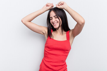 Young caucasian woman isolated on white background celebrating a special day, jumps and raise arms with energy.