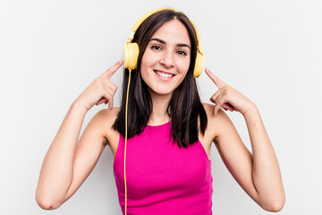 Young caucasian woman listening to music isolated on white background