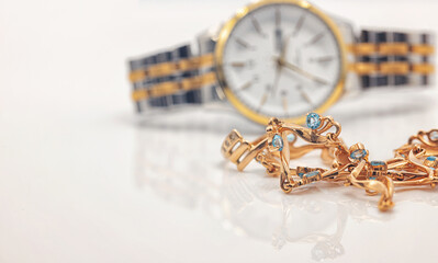 Elegant women's wristwatch with a bimetallic bracelet and a gold necklace with topaz