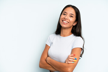 hispanic pretty woman laughing happily with arms crossed, with a relaxed, positive and satisfied...