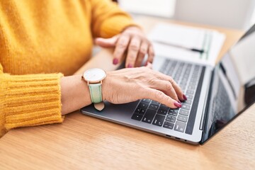 Middle age blonde woman business worker using laptop at office