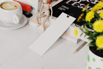 Paper bookmark at workplace mockup. 3D rendering