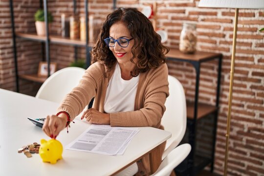 Middle Age Hispanic Woman Doing Home Finances At Home