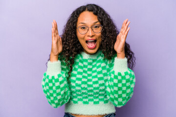 Young hispanic woman isolated on purple background laughs out loudly keeping hand on chest.