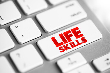 Life skills - abilities for adaptive and positive behaviour that enable humans to deal effectively with the challenges of life, text concept button on keyboard
