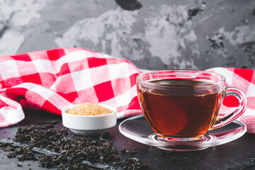 cup of black tea on a black stone background