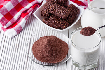 chocolate cocoa milk powder on a white wooden rustic background