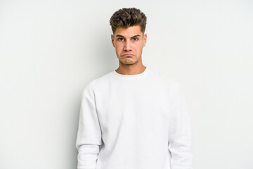 Young caucasian man isolated on white background sad, serious face, feeling miserable and displeased.