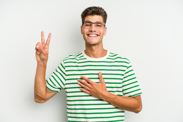 Fototapeta premium Young caucasian man isolated on white background taking an oath, putting hand on chest.