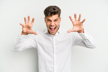Young caucasian man isolated on white background showing claws imitating a cat, aggressive gesture.