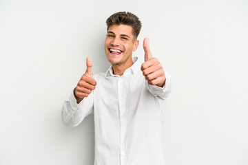 Young caucasian man isolated on white background raising both thumbs up, smiling and confident.