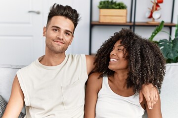 Obraz premium Man and woman couple smiling confident hugging each other at home