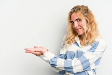 Naklejka premium Young caucasian woman isolated on white background holding a copy space on a palm.