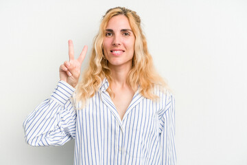 Young caucasian woman isolated on white background joyful and carefree showing a peace symbol with fingers.