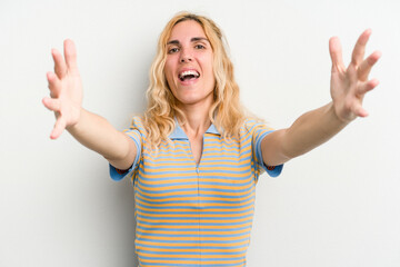 Young caucasian woman isolated on white background celebrating a victory or success, he is surprised and shocked.