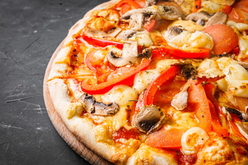 hot delicious traditional italian pizza on a dark stone background