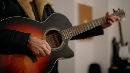 Musician man playing guitar at music studio