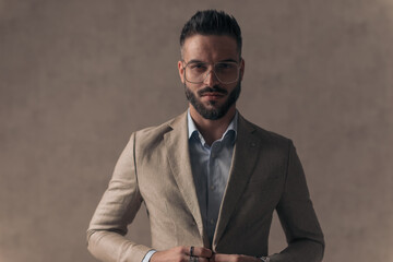 portrait of handsome businessman unbuttoning and opening suit