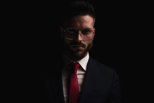 portrait of handsome businessman with glasses wearing elegant suit