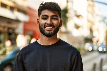 Young arab man smiling confident at street