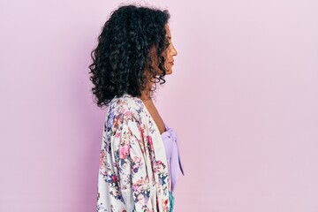 Young latin girl wearing casual clothes looking to side, relax profile pose with natural face with confident smile.