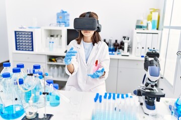 Young hispanic girl wearing virtual reality glasses at laboratory