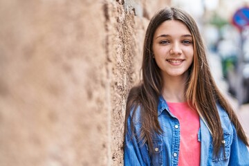 Adorable girl smiling confident looking to the camera at street