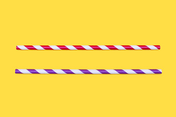 Two multi-colored straws for drinking on a yellow background. The concept of a children's holiday or birthday. Eco-friendly paper drinking straws