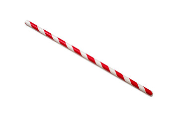 A red and white straw is placed diagonally on a white background. The concept of a children's...