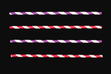 Four multi-colored drinking straws are arranged in parallel on a black background. Paper...