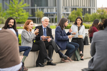 Colleagues on a lunch break in the financial district park, people of different ages.