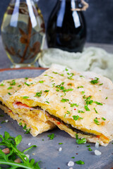 Fried pita bread with scrambled eggs, tomatoes, meat and cheese. Stuffed lavash