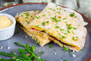 Fried pita bread with scrambled eggs, tomatoes, meat and cheese. Stuffed lavash