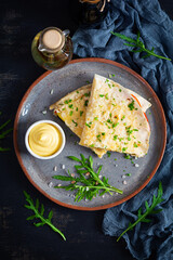 Fried pita bread with scrambled eggs, tomatoes, meat and cheese. Stuffed lavash