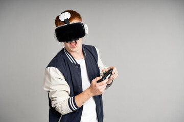 Young man wearing virtual reality simulator at studio shot
