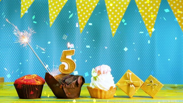 Happy birthday video card with number 5. A beautiful background for a happy birthday greeting with a muffin pie and a cake in blue and yellow shades with candles and a begal fire. Copy space