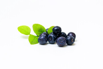 Sweet blueberries close-up on a white background. and green leaves.