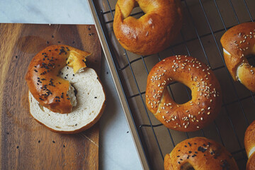 Homemade sliced sourdough Begals Bread Sesame Seeds on a wooden cutting board
