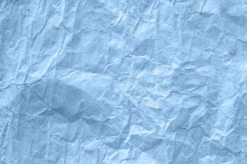 High detail of the abstract texture of the packaging paper. The texture of crumpled blue craft paper. Crumpled blue paper background top view. The texture of crumpled blue paper. Space for text.