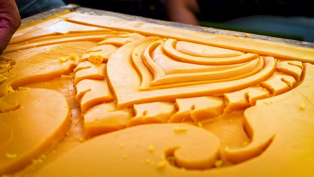 Artist using carving knife to carving candles for candle festival in Thailand.