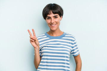 Young caucasian woman with a short hair cut isolated showing victory sign and smiling broadly.